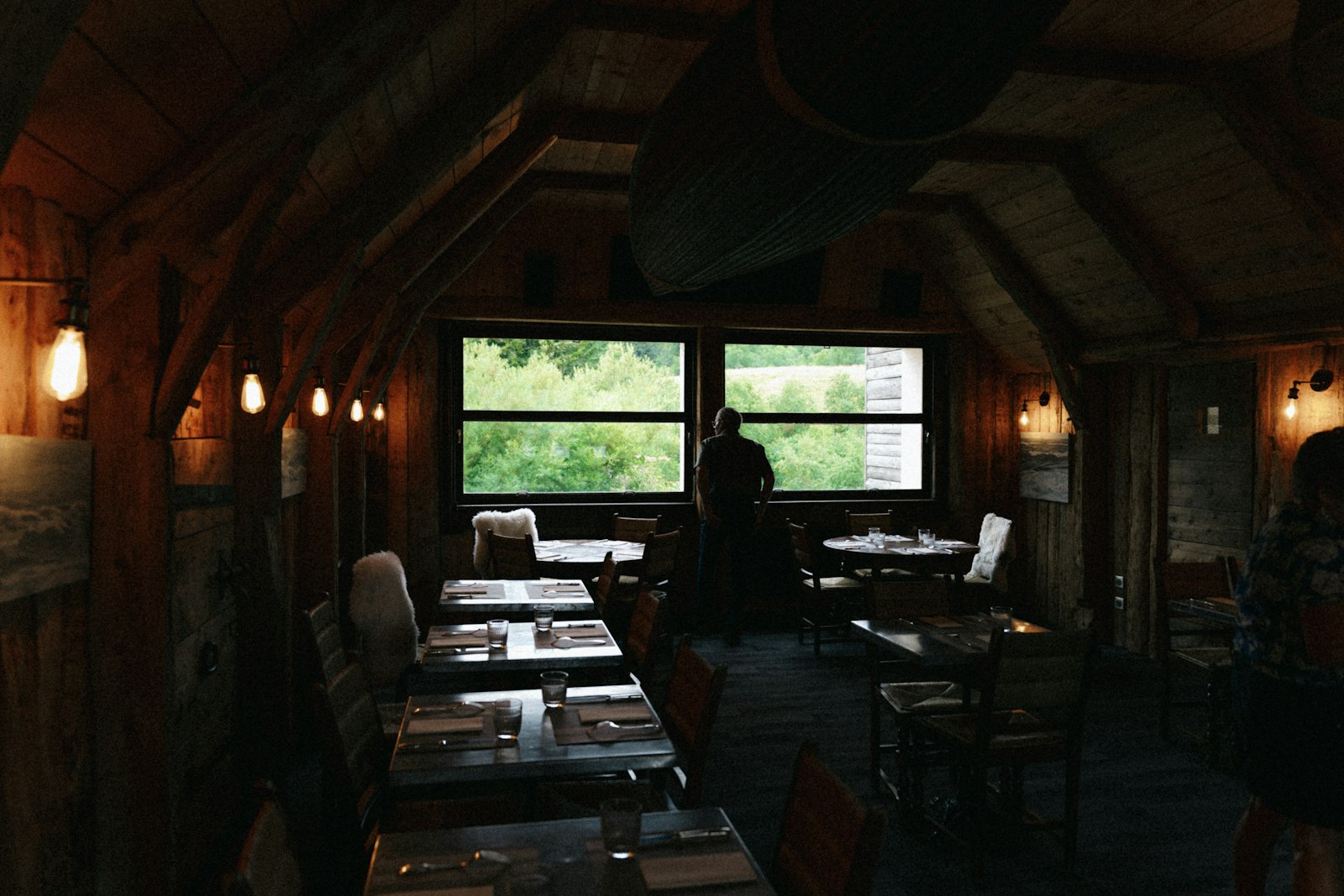 Warm, cozy dining room interior with large windows